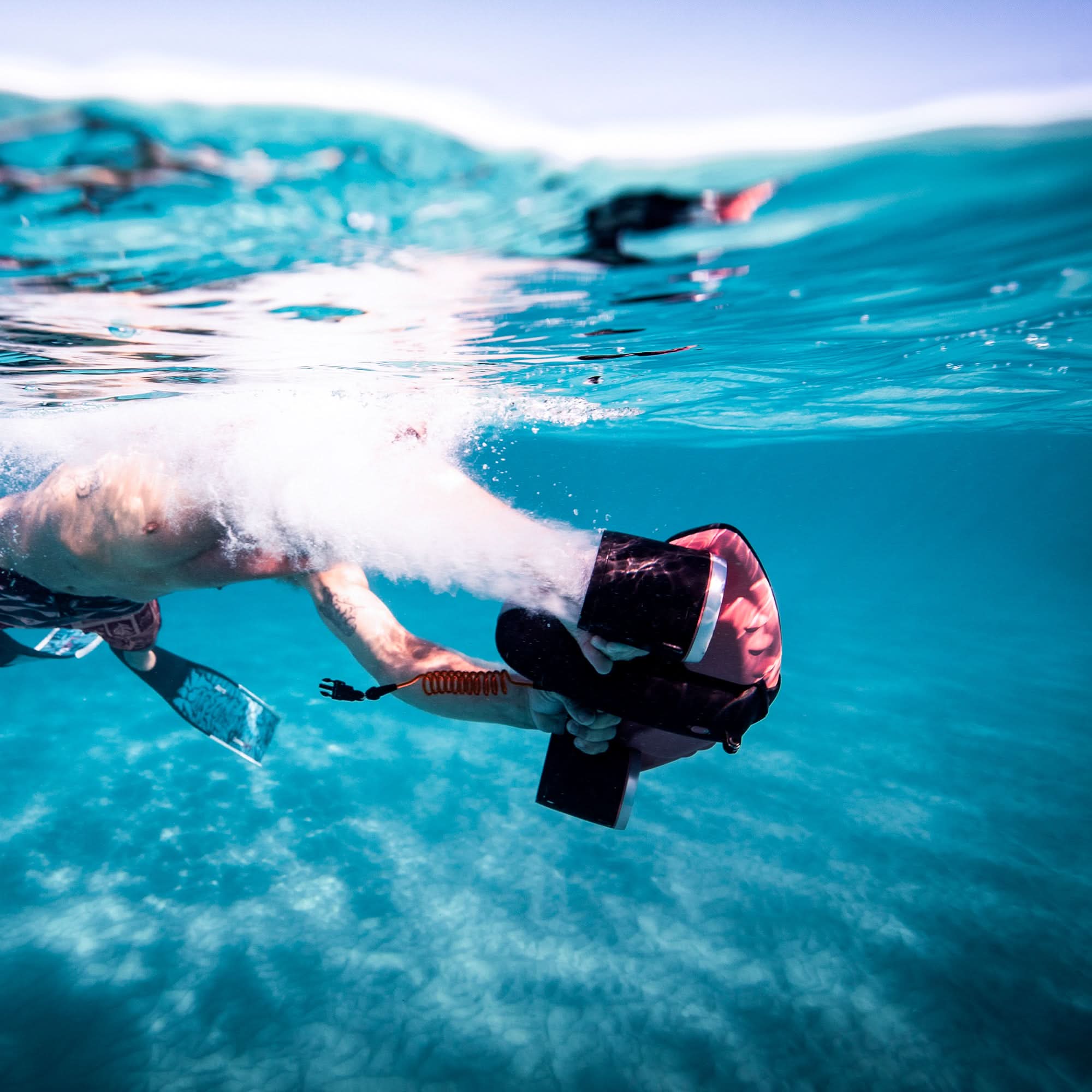 User using SUBLUE Navbow underwater scooter with a thrust in clear water.