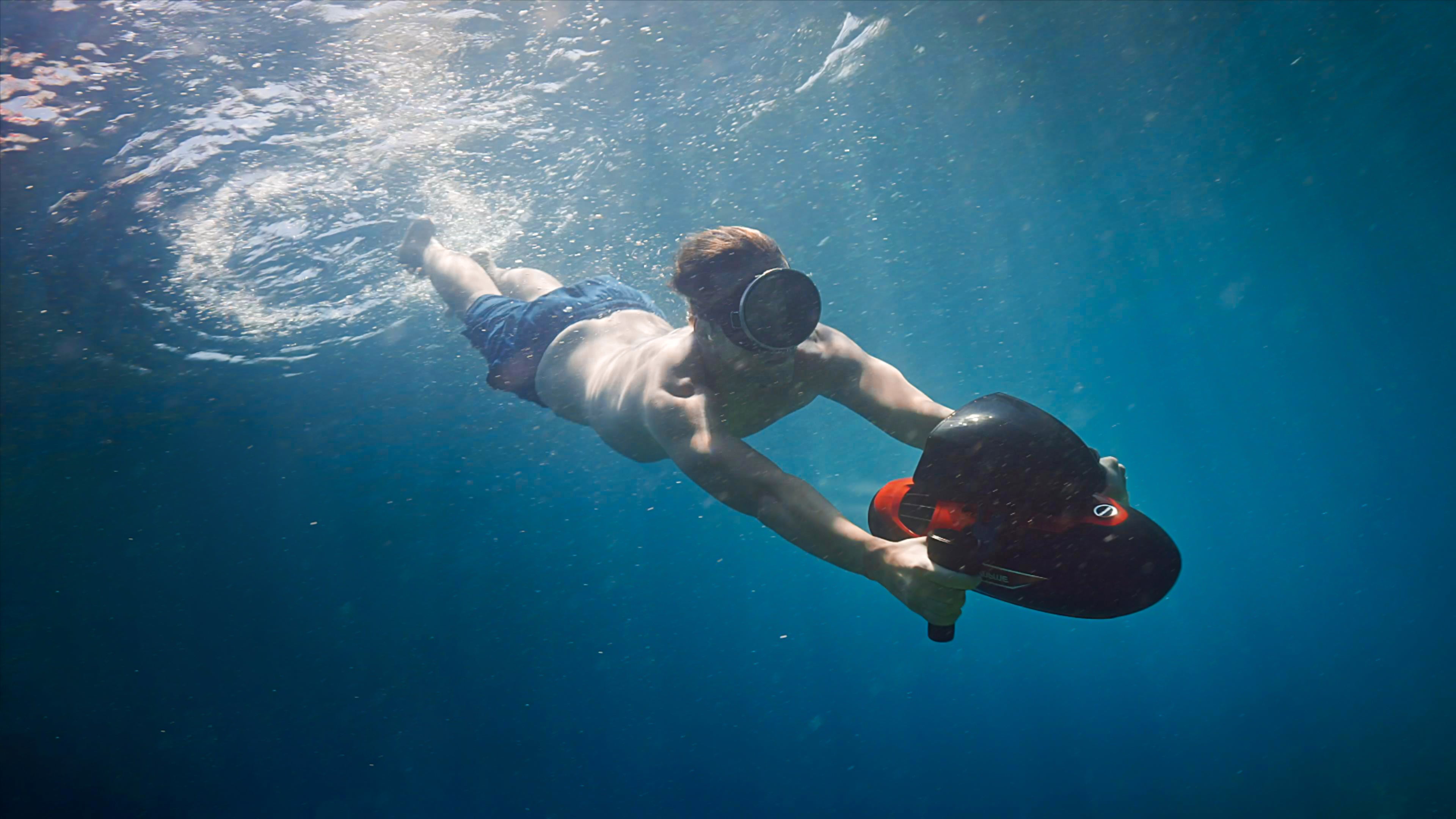 A man using an underwater scooter