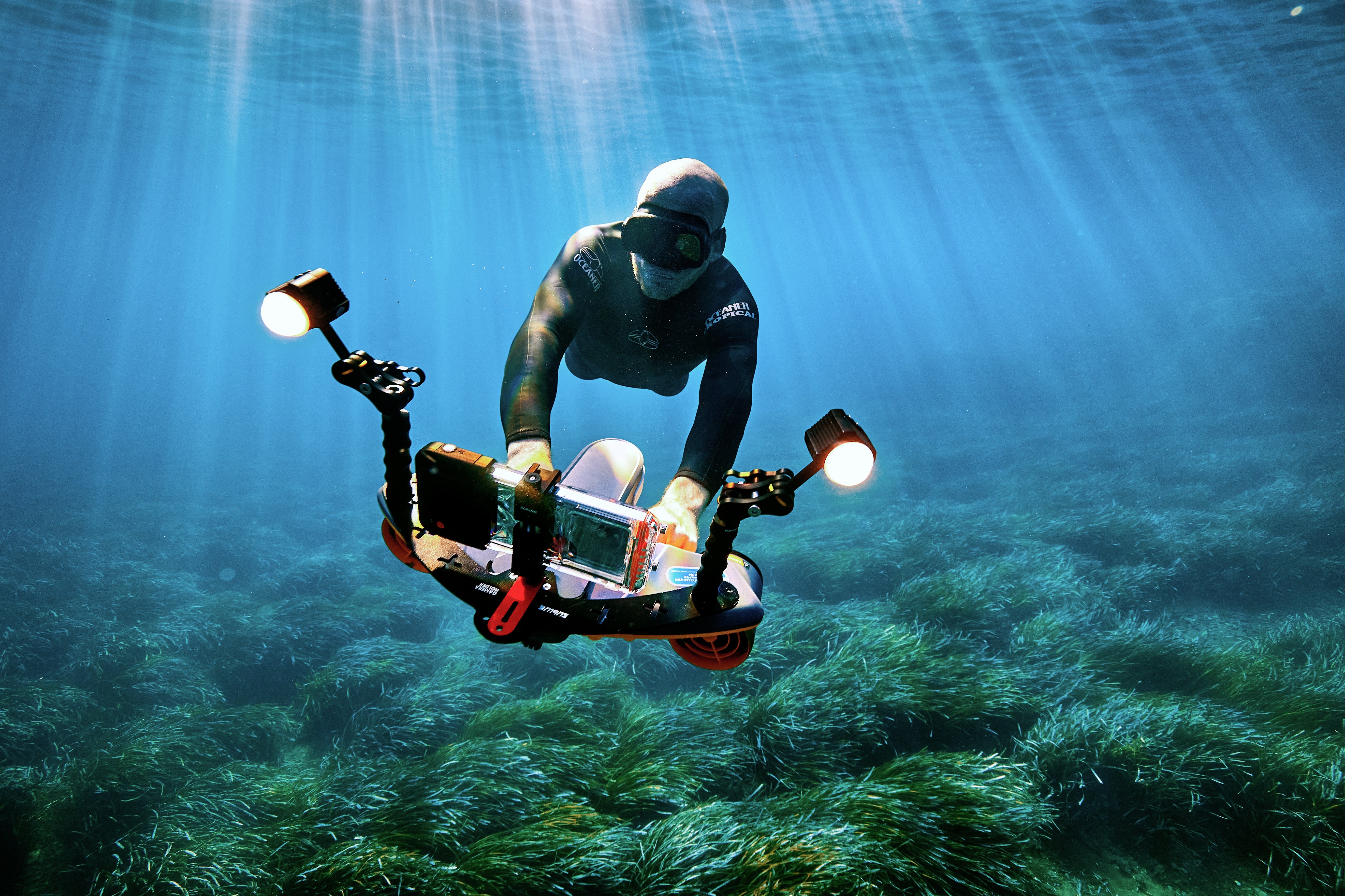 Two snorkelers explore marine life with underwater scooter