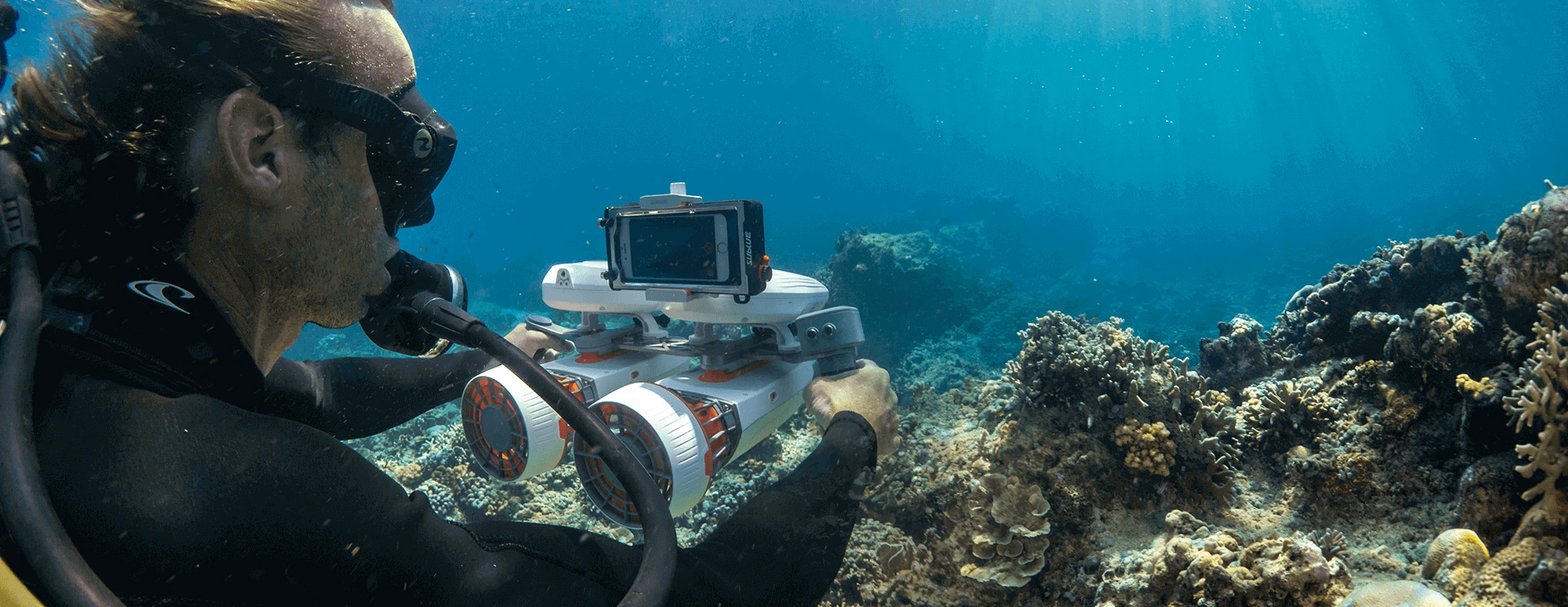 a person holding a camera underwater