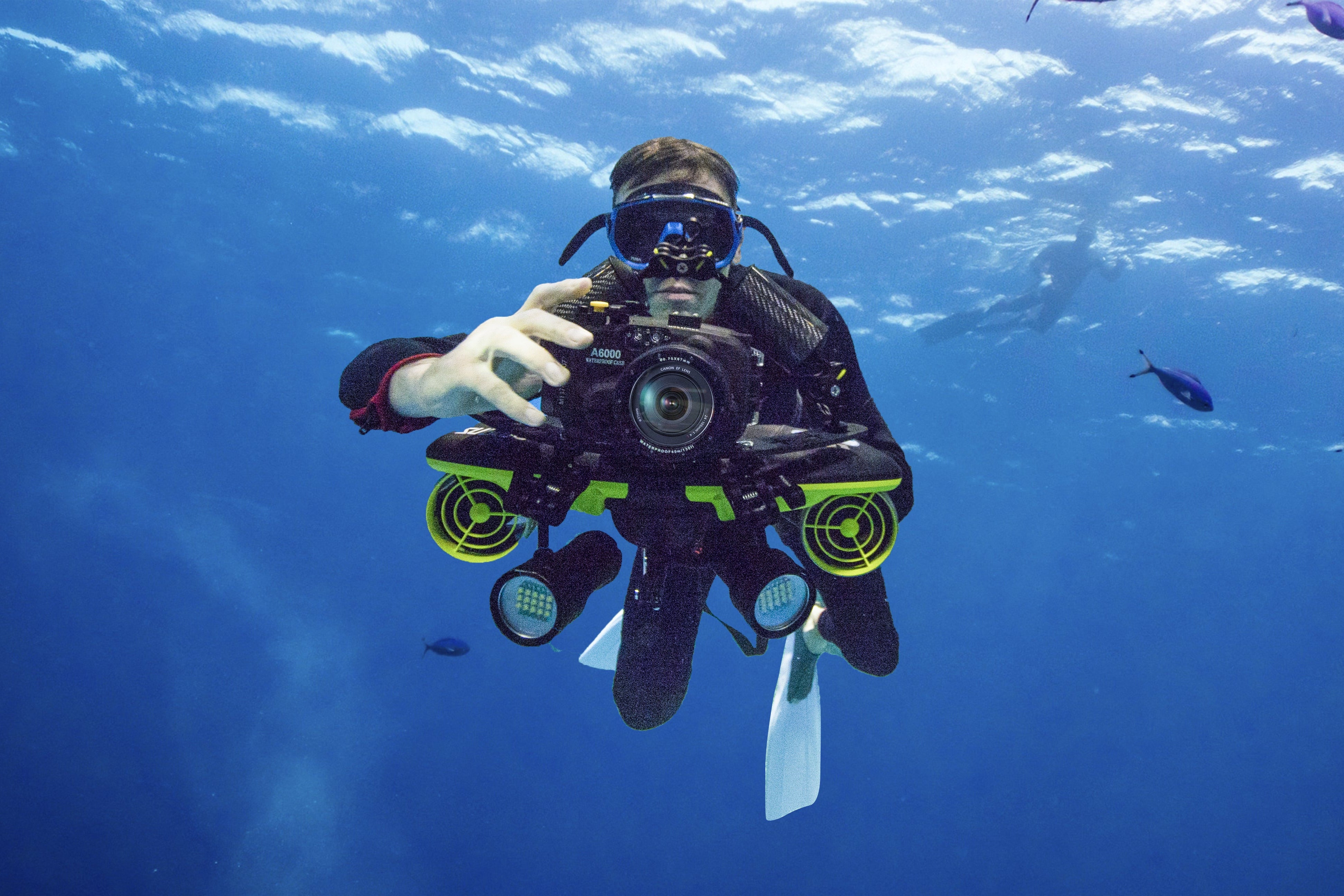 Diver photographing fish with Navbow base plate and camera underwater.