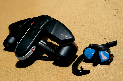 SUBLE Navbow+ underwater scooter and diving mask on sandy beach.