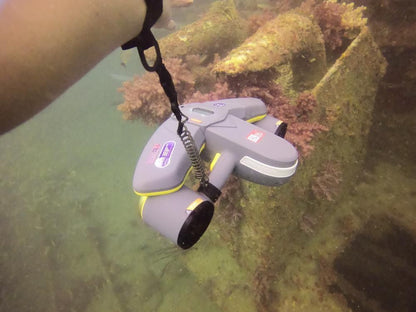 Sublue underwater scooter with anti-lost lanyard near underwater vegetation.