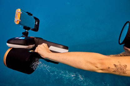 Diver using SUBLUE Navbow+ underwater scooter with camera mount in clear blue water.