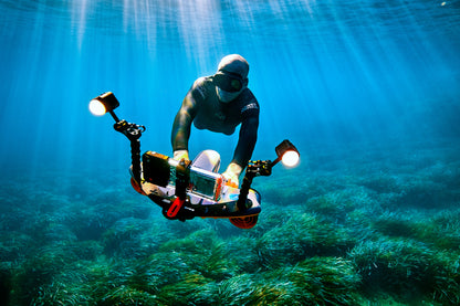 Diver operating Sublue Waterproof LED Light for underwater exploration