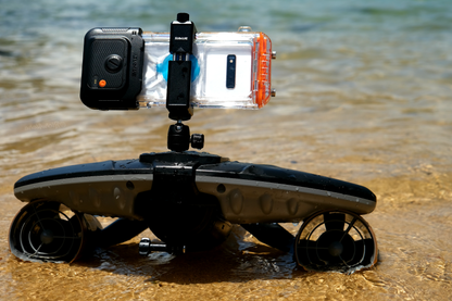 Sublue H1 waterproof phone case mounted on underwater scooter in shallow water.