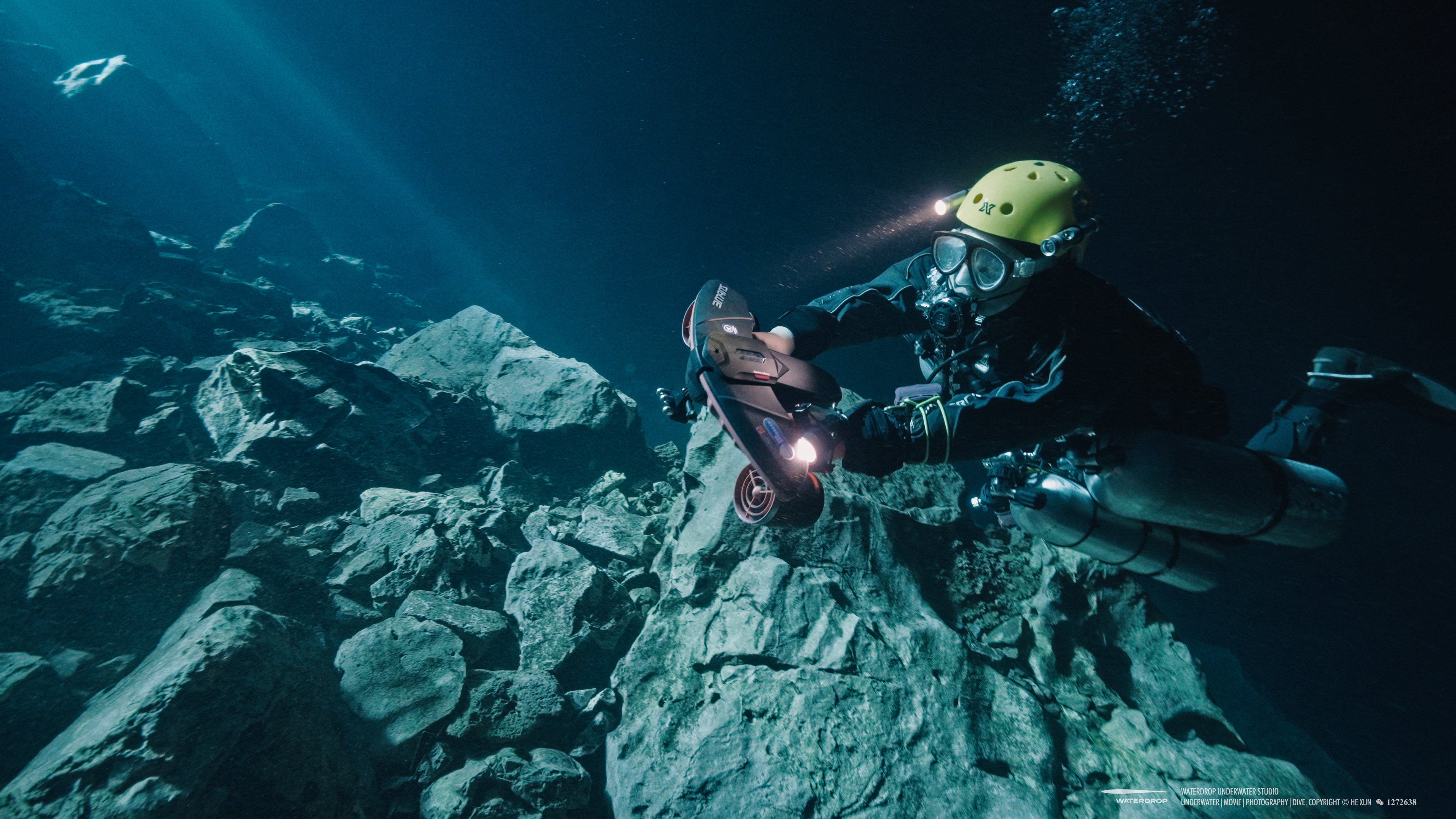 Diver using Navbow underwater scooter in rocky environment