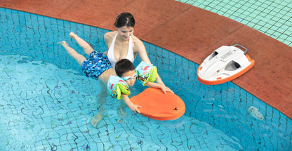 Child using orange swim board with inflatable armbands in a pool