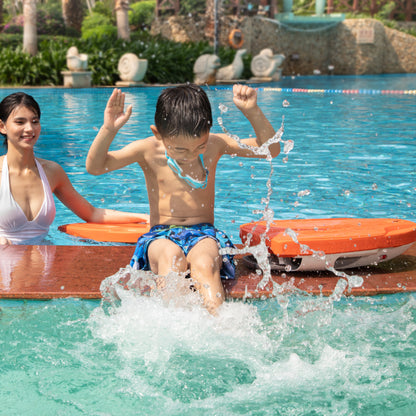 Child jumping into the pool with SUBLUE Swii kickboard and adult nearby.