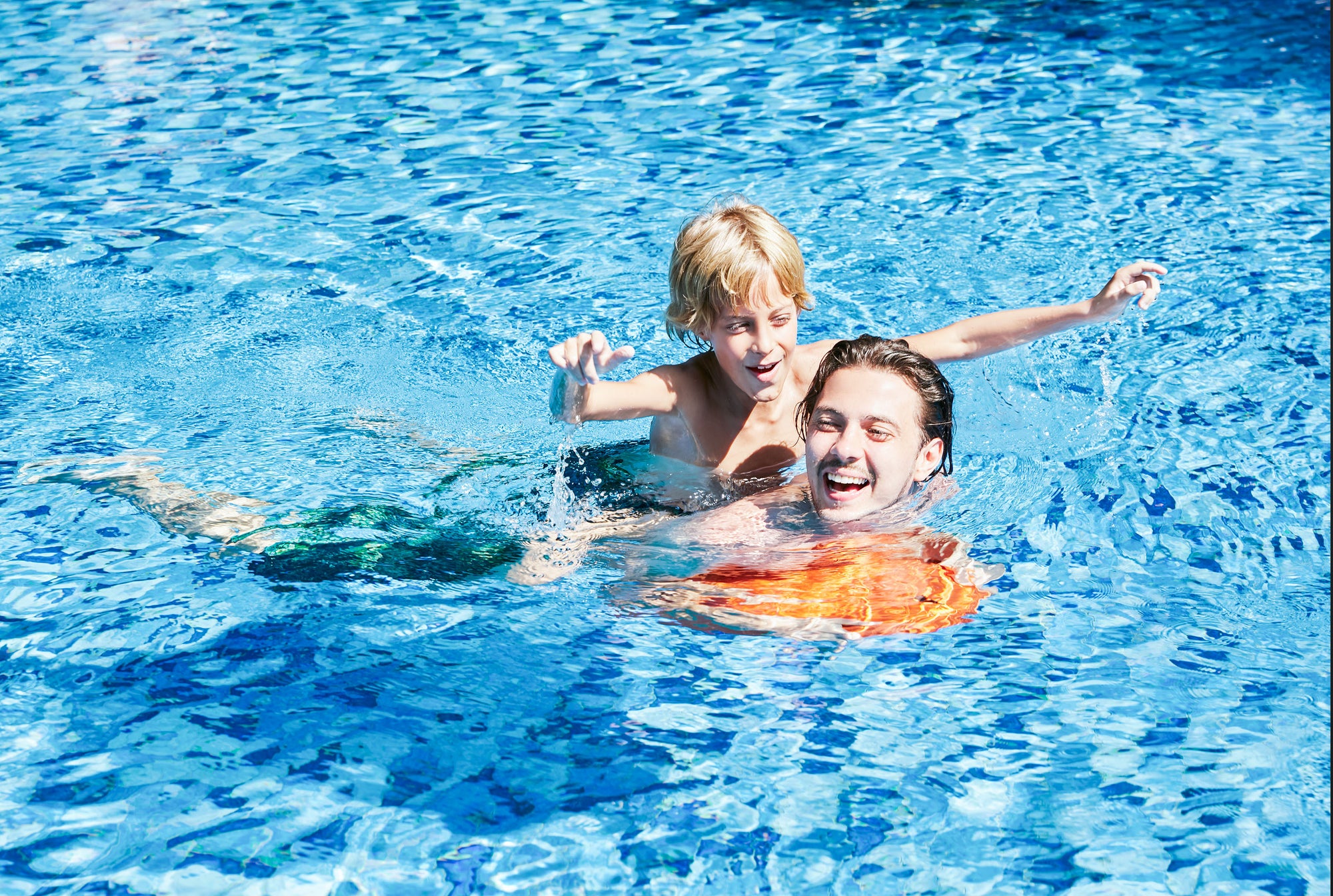 a man and boy in a pool