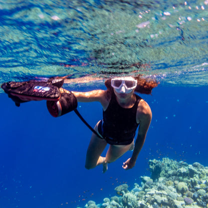 Diver using Sublue Diving Cross Strap to explore a coral reef underwater.