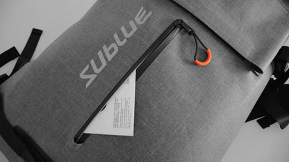 Close-up of Sublue waterproof backpack showing external zippered pocket and logo.